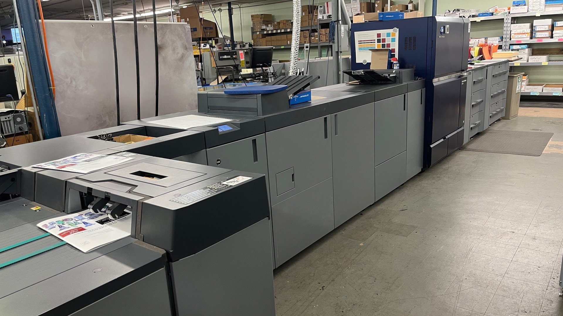 Commercial printing press producing brochures and business cards at Broadstroke facility in Wichita KS